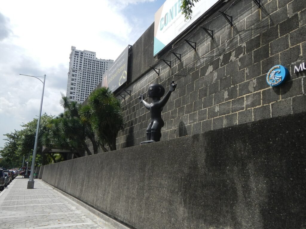 The Metropolitan Museum of Manila on Roxas Boulevard, a sculpture and an exhibition banner on its exterior wall
